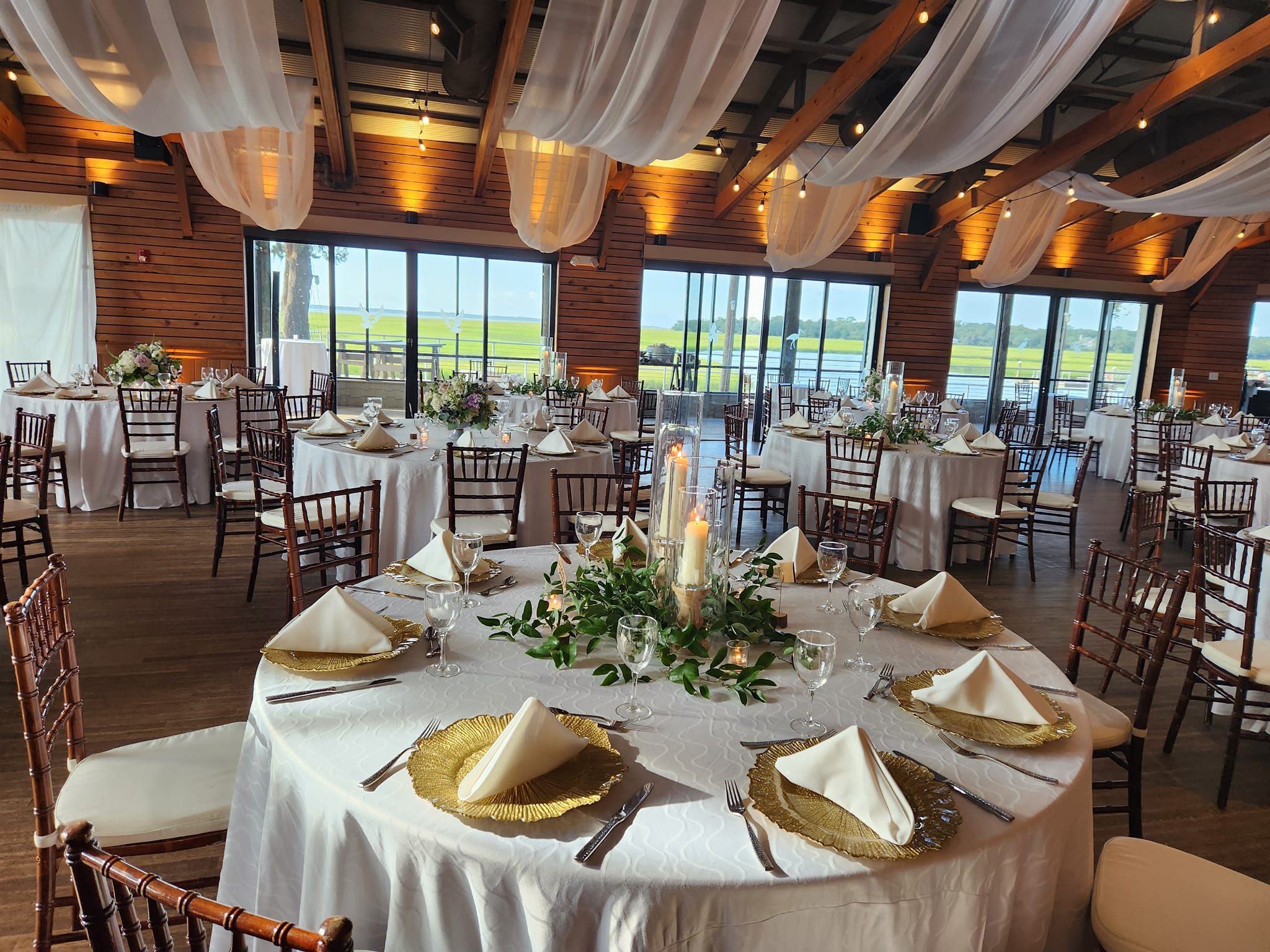 Candlelit banquet table at an ExcStand wedding reception at golden hour